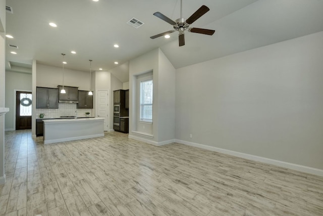 unfurnished living room featuring visible vents, baseboards, light wood-style floors, and a ceiling fan