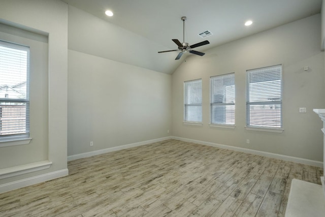 empty room with wood finished floors, a healthy amount of sunlight, baseboards, and ceiling fan