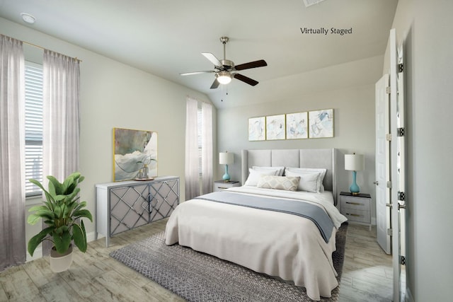 bedroom with multiple windows, wood finished floors, and a ceiling fan