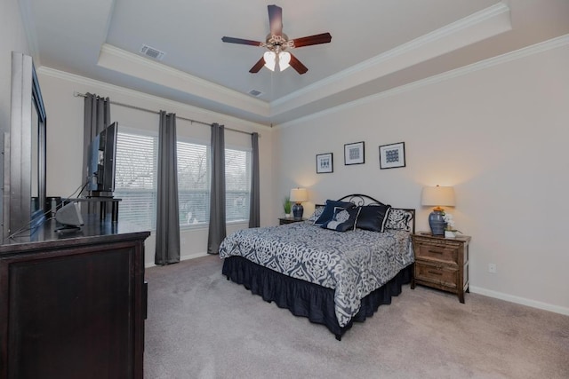 bedroom with a raised ceiling, light colored carpet, and visible vents