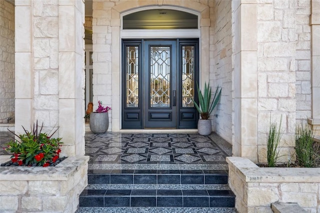 entrance to property with stone siding