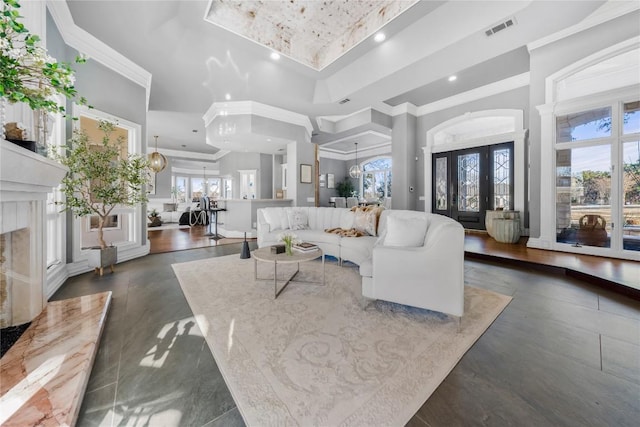 living room with visible vents, ornamental molding, recessed lighting, a fireplace, and a raised ceiling