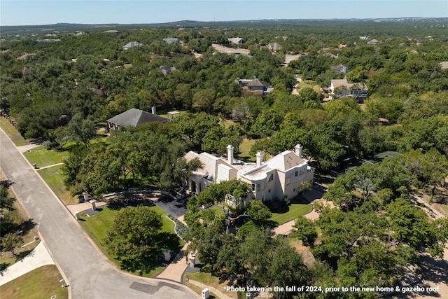 birds eye view of property with a view of trees