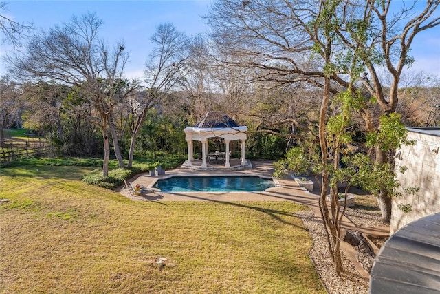 pool featuring a patio, a yard, and fence