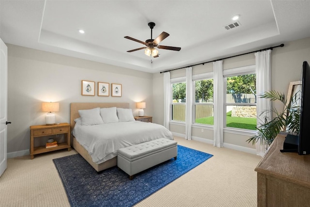 bedroom featuring a raised ceiling, baseboards, and visible vents