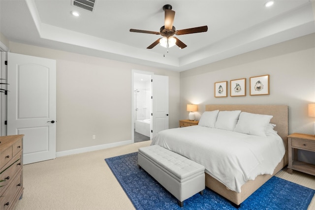 bedroom featuring visible vents, baseboards, light colored carpet, a tray ceiling, and recessed lighting