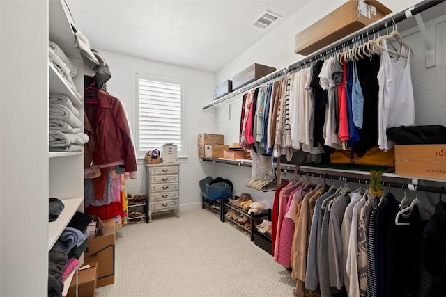 spacious closet with carpet flooring and visible vents