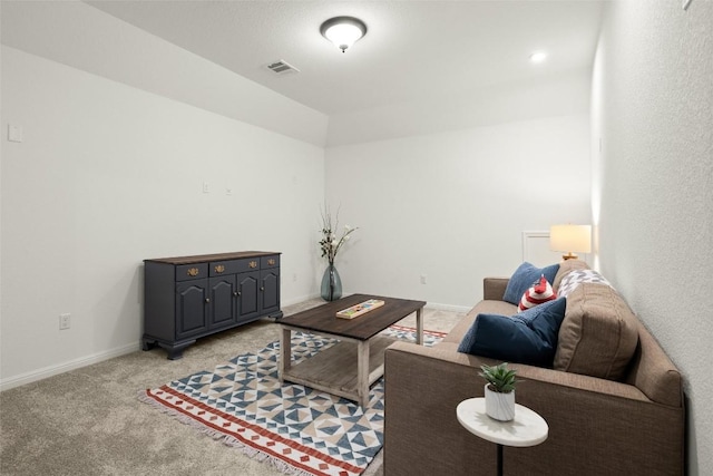 living room with visible vents, baseboards, and light colored carpet