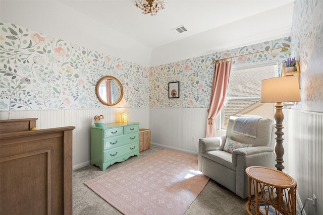 sitting room with visible vents, carpet flooring, wainscoting, and wallpapered walls