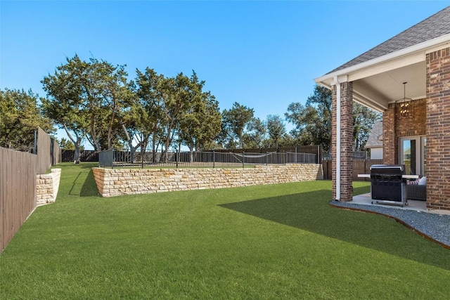 view of yard featuring a patio area and a fenced backyard