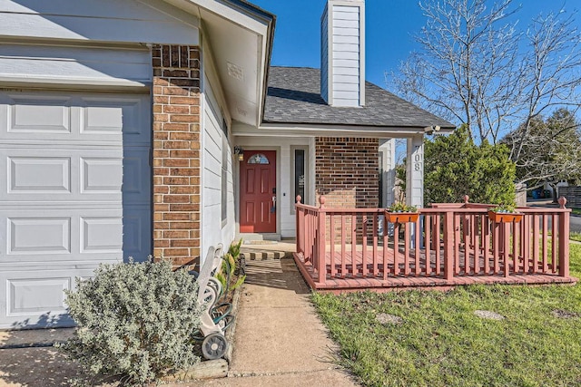 property entrance with a garage, brick siding, roof with shingles, and a chimney