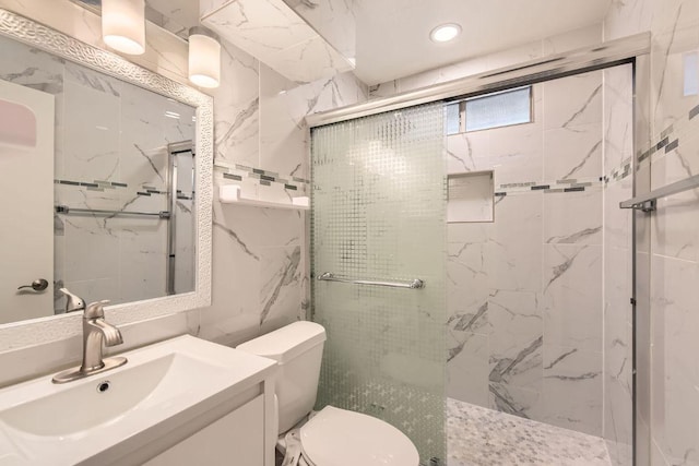 bathroom featuring vanity, toilet, and a marble finish shower