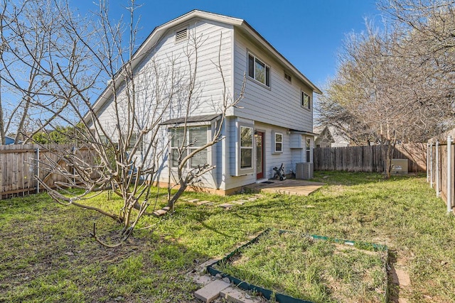 back of property with cooling unit, a lawn, and a fenced backyard