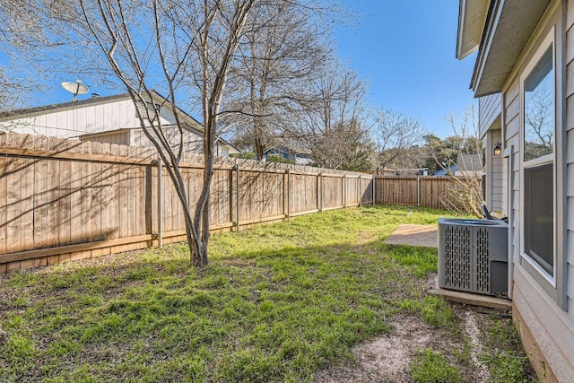 view of yard featuring central air condition unit and a fenced backyard