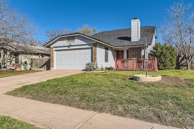 view of front of home with driveway, a front yard, an attached garage, brick siding, and a chimney