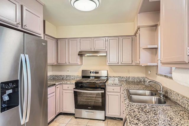 kitchen with light stone counters, light tile patterned floors, a sink, stainless steel appliances, and under cabinet range hood