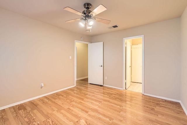 unfurnished bedroom featuring light wood-type flooring, baseboards, visible vents, and ceiling fan