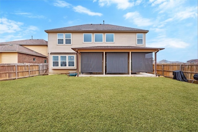 back of house featuring a lawn, a patio, and a fenced backyard