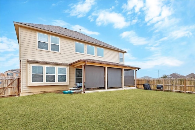 back of house with a yard, a patio, and a fenced backyard