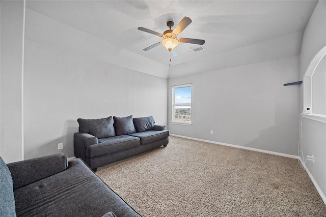 carpeted living room featuring visible vents, a ceiling fan, and baseboards