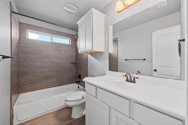 full bathroom featuring vanity, wood finished floors, visible vents, shower / bath combination, and toilet