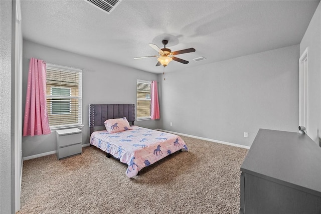 bedroom featuring visible vents, baseboards, carpet, and a textured ceiling