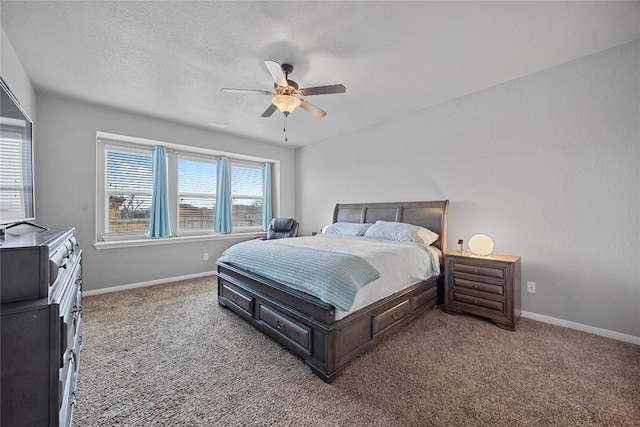 bedroom featuring a ceiling fan, baseboards, carpet floors, and a textured ceiling