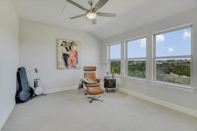 living area featuring lofted ceiling, baseboards, and carpet floors