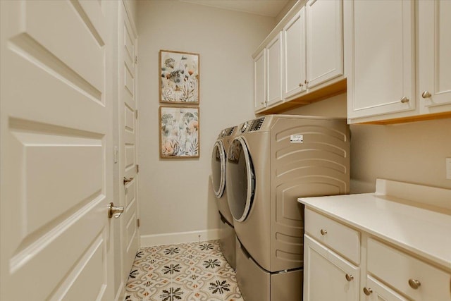 washroom with light tile patterned floors, baseboards, cabinet space, and independent washer and dryer