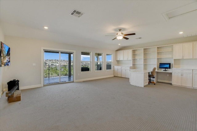 unfurnished living room with baseboards, visible vents, built in study area, recessed lighting, and light carpet