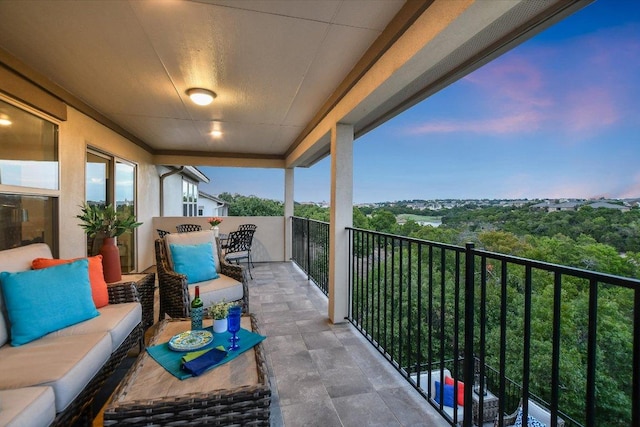 balcony with an outdoor hangout area and a sunroom