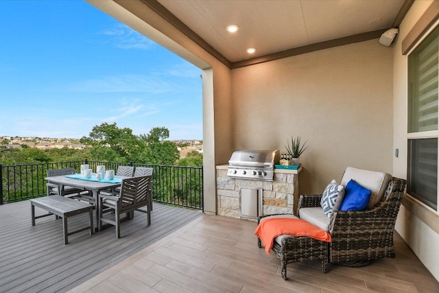 balcony with outdoor dining area and a grill