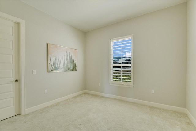 unfurnished room with baseboards and carpet floors