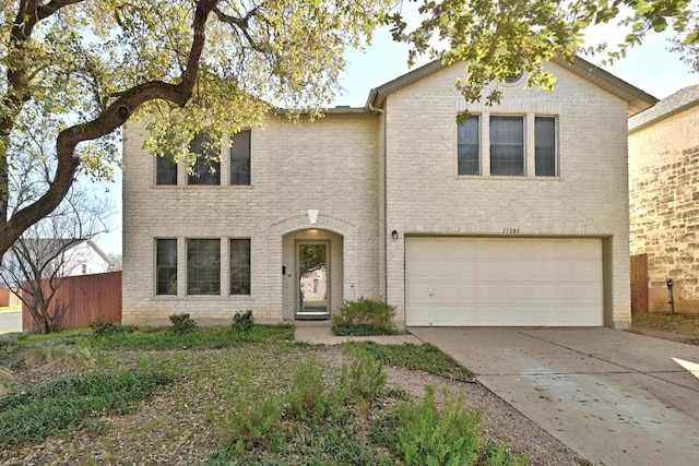 traditional-style house featuring a garage and concrete driveway