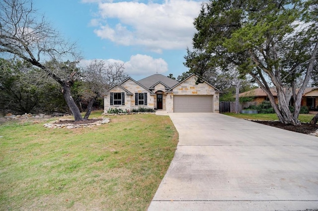 ranch-style home featuring driveway, a front lawn, stone siding, fence, and a garage