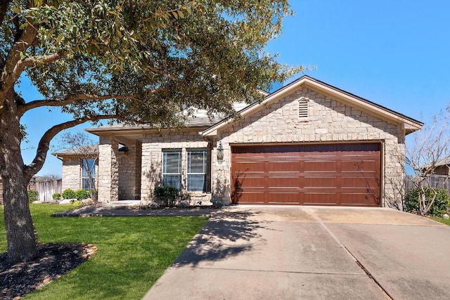 view of front facade featuring concrete driveway, an attached garage, stone siding, and a front yard