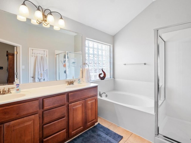 full bathroom with tile patterned floors, vaulted ceiling, a stall shower, and a sink