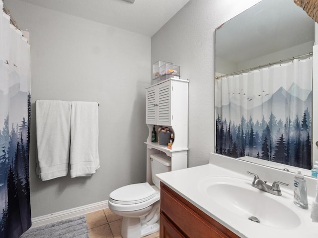 bathroom featuring baseboards, toilet, a shower with curtain, tile patterned floors, and vanity