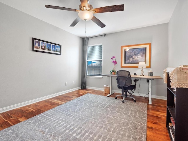 home office featuring baseboards, wood finished floors, and a ceiling fan