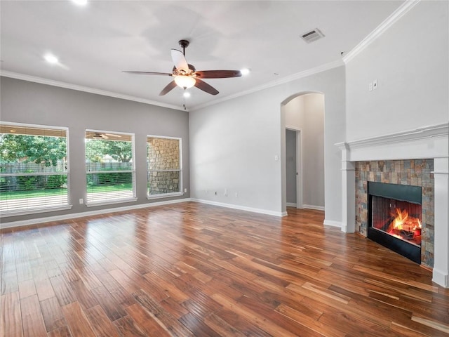 802 Wood Mesa Dr, Round Rock, TX 78665 - unfurnished living room featuring ceiling fan, wood finished floors, a fireplace, arched walkways, and recessed lighting