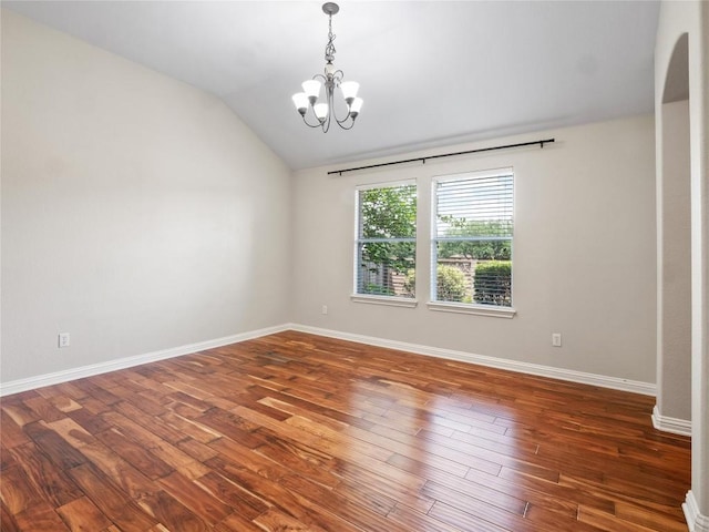 802 Wood Mesa Dr, Round Rock, TX 78665 - unfurnished room with a chandelier, vaulted ceiling, wood finished floors, and arched walkways