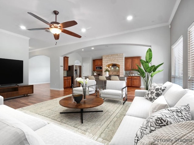 802 Wood Mesa Dr, Round Rock, TX 78665 - living room with light wood-type flooring, arched walkways, crown molding, a ceiling fan, and recessed lighting