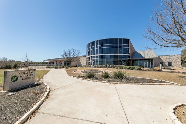 view of building exterior featuring concrete driveway