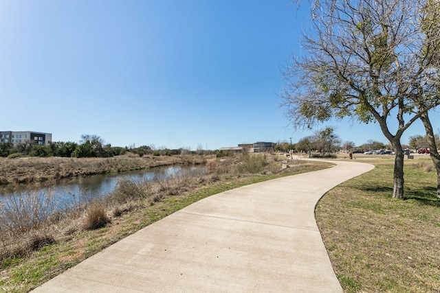 view of home's community with a yard and a water view