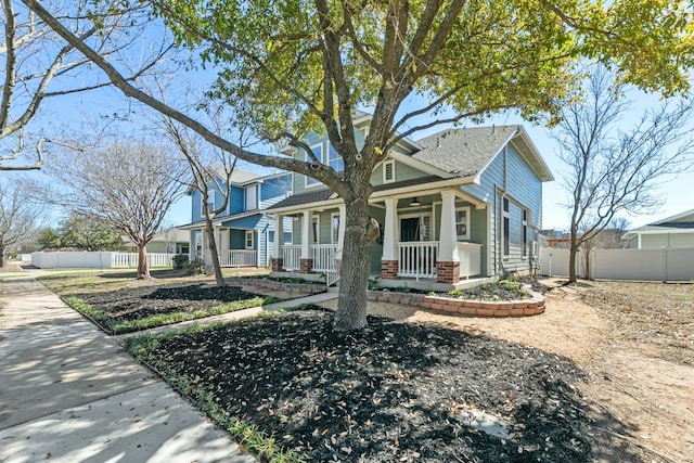 view of front of property featuring covered porch and fence