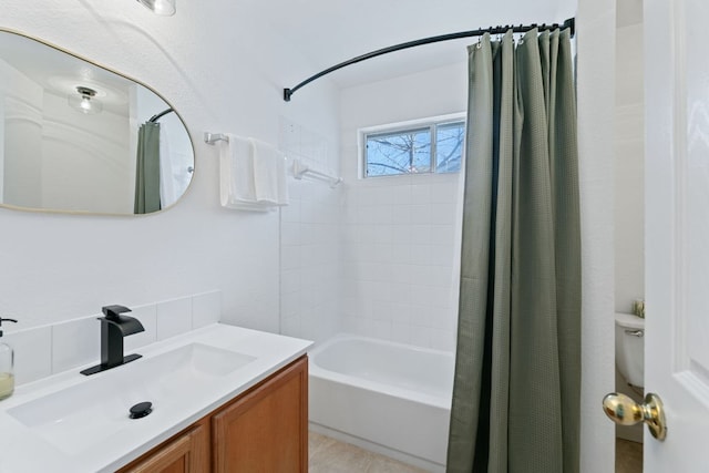 bathroom featuring vanity and shower / bathtub combination with curtain