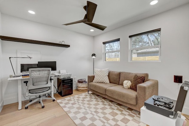 home office featuring recessed lighting, baseboards, a ceiling fan, and light wood finished floors