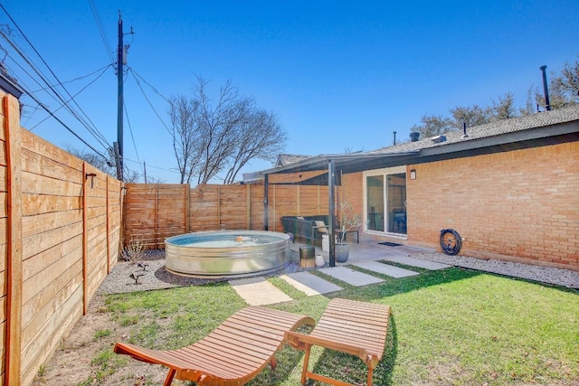 view of yard featuring a patio area and a fenced backyard