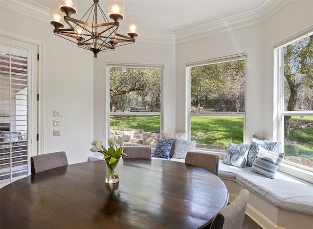 dining space with crown molding and a notable chandelier