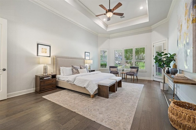 bedroom with baseboards, a tray ceiling, ornamental molding, dark wood-style floors, and access to outside